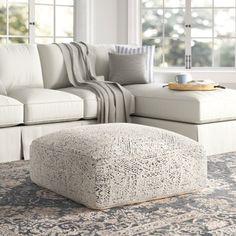 a living room scene with focus on the ottoman