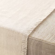 a close up view of the textured fabric on a bed sheet that has been made with natural linens