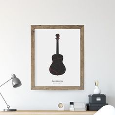 a guitar is hanging on the wall above a desk