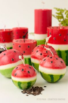 some watermelon slices and candles are sitting on a table with seeds around them