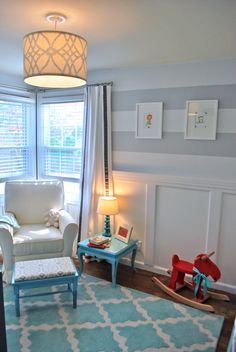 a living room filled with furniture and a baby's crib next to a window