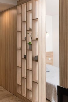 a bedroom with wooden walls and shelves on the wall