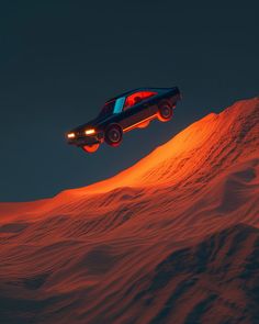 a car is flying through the air over some snow covered hills at night with its headlights on