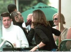 a group of people sitting at an outdoor table