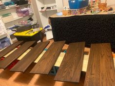 several different types of wood flooring are on display in a room with shelves and bins