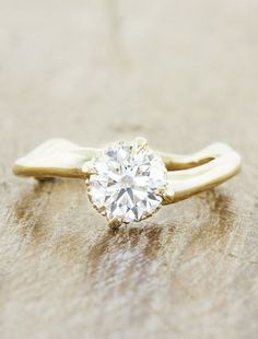 a gold ring with a diamond on it