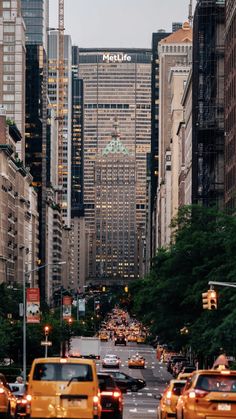 a city street filled with lots of traffic and tall buildings