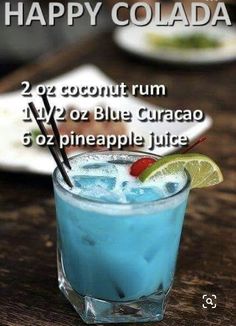 there is a blue curacao cocktail with ice and lime on the rims