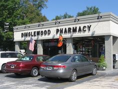 two cars parked in front of a pharmacy