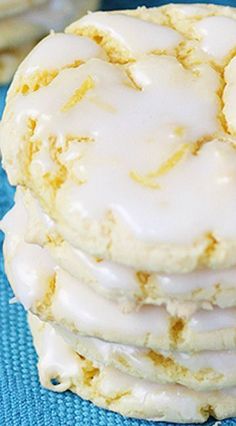 a stack of iced cookies sitting on top of a blue cloth