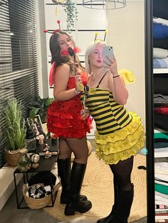 two women dressed in costumes taking a selfie