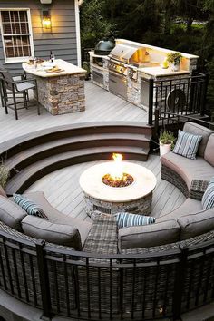 a fire pit sitting on top of a wooden deck next to a table and chairs