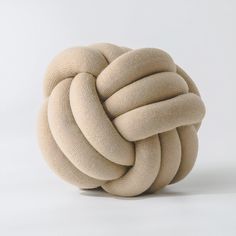 a knoted cushion sitting on top of a white surface