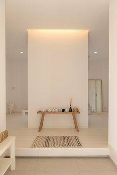 a white room with a table and two benches