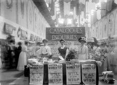 an old black and white photo of people in a store with signs that say catalogues enquiries