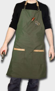 a man wearing an apron and holding a knife