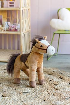 a stuffed horse is standing on a rug