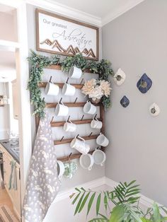 there is a coffee cup rack on the wall with cups and mugs hanging from it