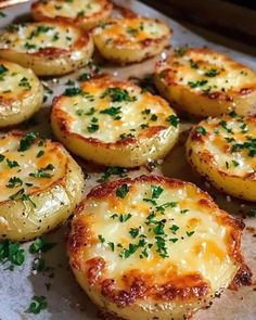 baked potatoes with cheese and parsley on a baking sheet