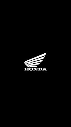 the honda logo is black and white with wings on it's back side, in front of a dark background