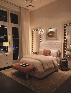 a bedroom with a bed, mirror and lights