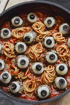 a pan filled with pasta covered in googly eyes