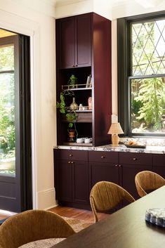 a dining room table and chairs in front of a window