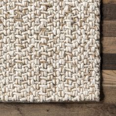 close up view of the woven fabric on a wooden surface with wood planks in the background