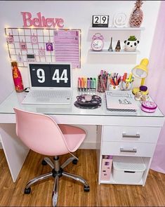 a white desk topped with a pink chair next to a desktop computer and calendars