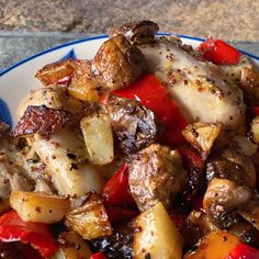 a blue and white plate topped with meat and veggies