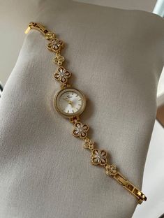 😱SOLD OUT 1,000 ON TikTok! Vintage Gold Clover Watch | Free Worldwide Shipping 🌎 Looking for the perfect gift for the special women in your life? Our Cleopatra's Clover Vintage Gold Watch is more than just a timepiece--it's a symbol of elegance and timeless style. This stunning watch is designed for the woman who appreciates both fashion and functionality. 💕 Product Features: ✨Elegant Design: A vintage-inspired watch with a classic gold clover dial, perfect for adding a touch of sophistication to any outfit. ✨High-Quality Materials: Crafted from durable stainless steel, ensuring longevity and a premium look. ✨Reliable Performance: A fully functional timepiece, perfect for everyday wear or special occasions. Dial Diameter: 23mm Dial Thickness: 7mm Strap Width: 13mm Total Length: 20cm Why Dainty Gold Watch Vintage, Vintage Gold Watch Women, Feminine Watches, Dainty Watch, Vintage Gold Watch, Watch Women's, Gold Watches Women, Vintage Watches Women, Cute Watches