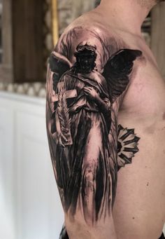 a man with an angel tattoo on his arm