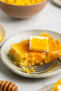 a piece of cake on a plate with a fork and honeycombs around it