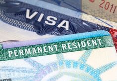 a visa card sitting on top of a pile of different types of paper money with the word permanent resident written on it