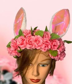 a mannequin head with pink flowers and bunny ears