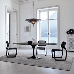 an elegant dining room with white walls and flooring