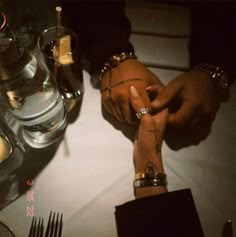 two people holding hands at a dinner table