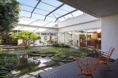 Taking cues from a traditional Japanese homethe 3,651-square-foot residence arranges itself around a courtyard garden boasting mature plants and a koi pond. Koi Fish Pond Inside House, Indoor Koi Pond Living Rooms, Fish Pond Design, Pond Design Ideas, Japanese Courtyard, Traditional Japanese Home