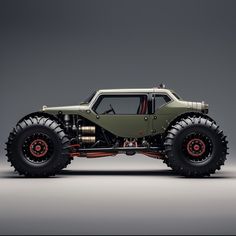 an off - road vehicle with large wheels and big tires is shown in front of a gray background