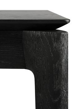 a close up of a wooden table with black woodgrain on the top and bottom