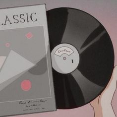 a record player is holding up a vinyl album with the title classic on it's cover