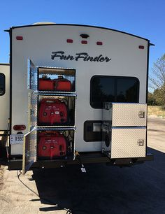 a white trailer with red luggage in the back