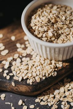 oats in a bowl on a wooden cutting board