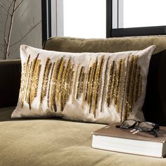 a pair of glasses sitting on top of a couch next to a book