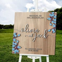 a wooden sign with blue flowers on it