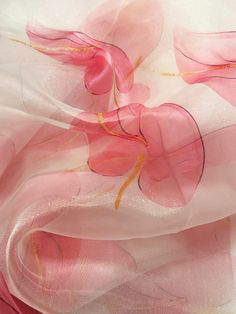 pink and white sheer fabric with gold lines on the bottom, as well as flowers