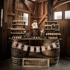 there is a cake on top of two barrels in the room with wooden walls and windows