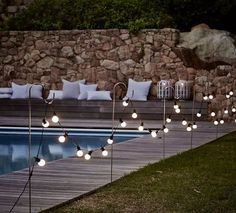 some lights that are next to a pool