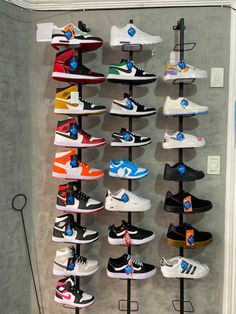 there are many pairs of shoes hanging on the wall