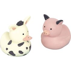 two rubber ducks and a cow are sitting next to each other on a white surface